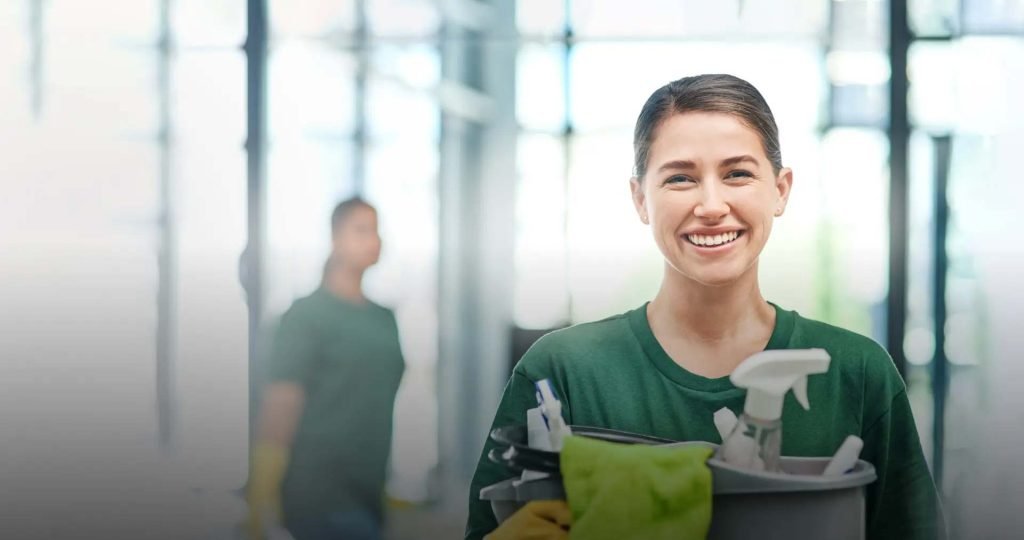 Residential cleaning expert from The Dust Busters Cleaning Company LLC smiling while holding a bucket of cleaning supplies. We proudly serve homes in Greensburg, Saltsburg, Indiana, PA, and nearby areas with reliable, professional house cleaning services.